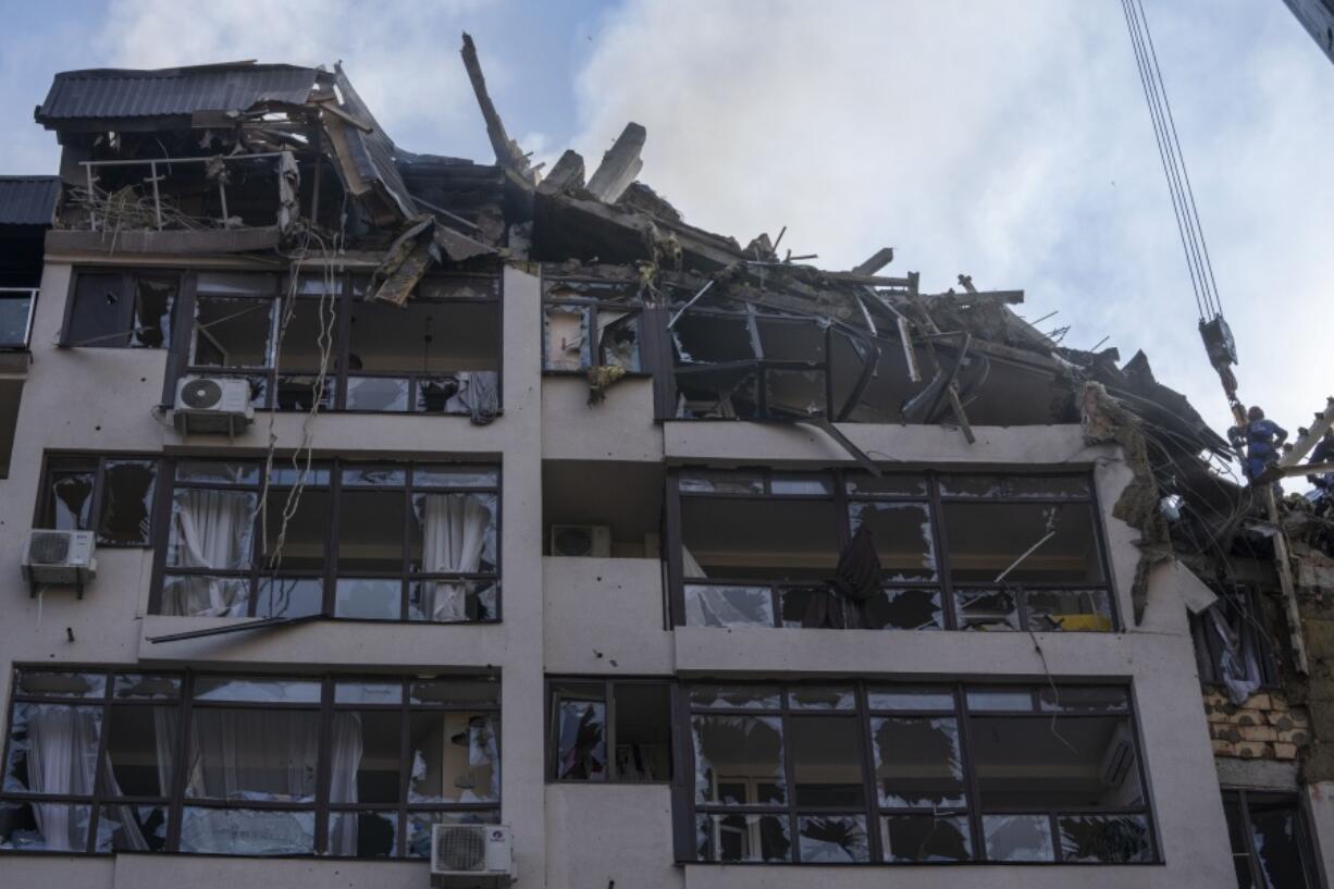Firefighters work at the scene of a residential building following explosions, in Kyiv, Ukraine, Sunday, June 26, 2022. Several explosions rocked the west of the Ukrainian capital in the early hours of Sunday morning, with at least two residential buildings struck, according to Kyiv mayor Vitali Klitschko.