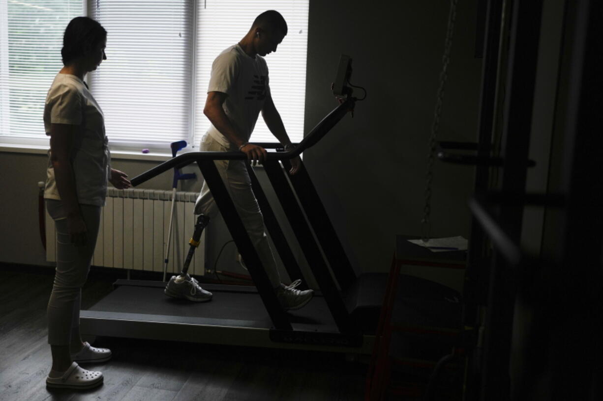 "Buffalo," the name he uses as a soldier, walks in a treadmill at a clinic in Kyiv, Ukraine, Friday, June 17, 2022. "Buffalo" was at the Azovstal plant, in an underground bunker-turned-medical station that provided shelter from death and destruction above. He was among those in the list for evacuation after being shredded by mortar rounds, losing his left leg above the knee.