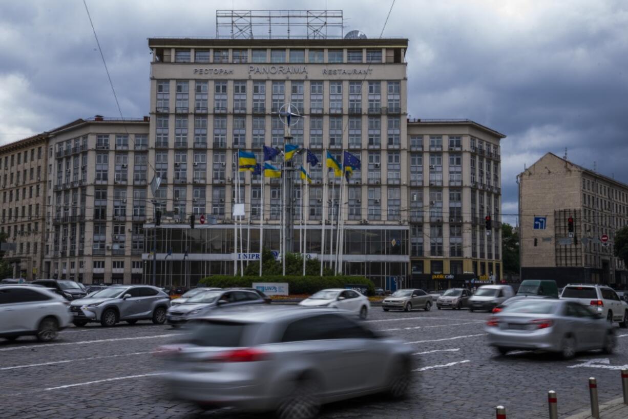 Ukrainian and EU flags on poles, in Kyiv, Ukraine, Thursday, June 23, 2022. European Union leaders on Thursday are set to grant Ukraine candidate status to join the 27-nation bloc, a first step in a long and unpredictable journey toward full membership that could take many years to achieve.