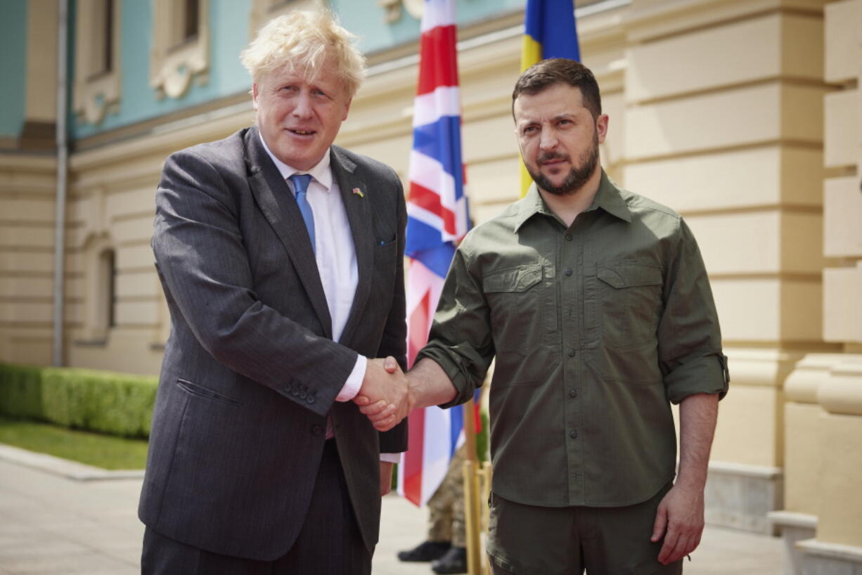 In this image provided by the Ukrainian Presidential Press Office, Ukrainian President Volodymyr Zelenskyy, right, and Britain's Prime Minister Boris Johnson, pose for a photo during their meeting in downtown Kyiv, Ukraine, Friday, June 17, 2022.
