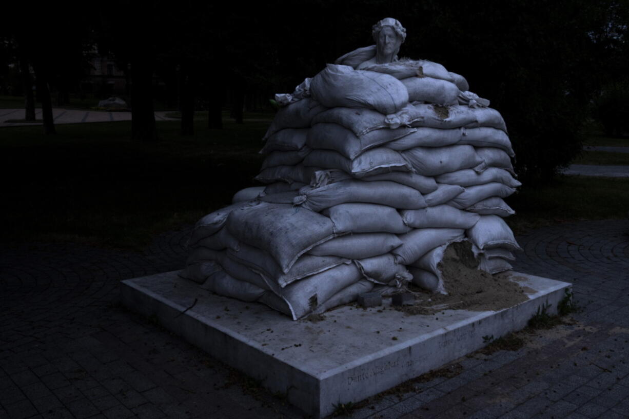 The sculpture of prominent Italian poet Dante Alighieri, is protected by sandbags, on Vladimir's Hill in Kyiv, Ukraine, Thursday, June 23, 2022.