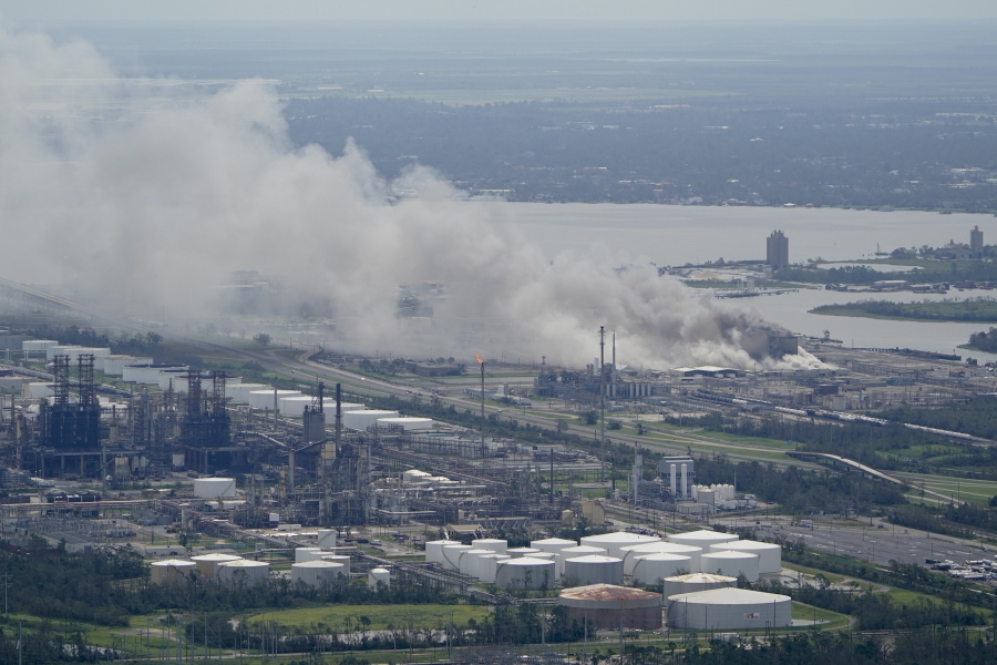 FILE - A chemical fire burns at a facility during the aftermath of Hurricane Laura, Aug. 27, 2020, near Lake Charles, La. The Securities and Exchange Commission moved closer Friday, June 17, 2022, to a final rule that would dramatically change what public companies tell shareholders about climate change. Companies would also have to disclose risks related to the physical impact of storms, drought and higher temperatures brought on by global warming.  (AP Photo/David J.