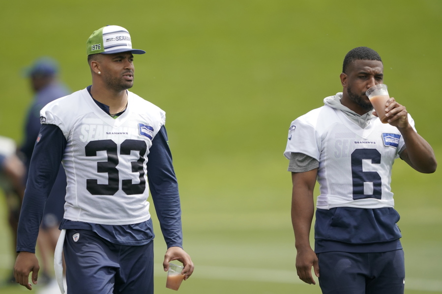 Seahawks strong safety Jamal Adams (33) and free safety Quandre Diggs (6) walk on the field minicamp practice Tuesday in Renton. (Ted S.