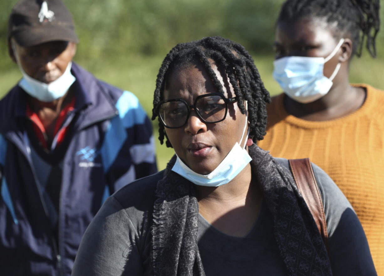 Yandiswa Ngqoza, with family members after identifying her daughters at the Woodbrook Mortuary in East London, South Africa Monday, June 27, 2022. South African authorities are seeking answers after 21 underage teenagers celebrating the end of school exams died in a mysterious weekend incident at a nightclub. The bodies of many of the victims were discovered by police lying on tables, slumped over chairs and sprawled on the floor of the club in the early hours of Sunday morning.