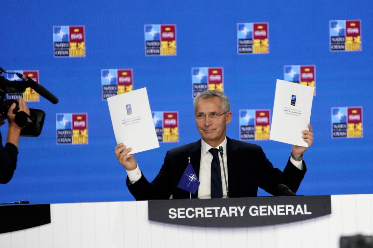 NATO Secretary General Jens Stoltenberg holds up a letter of commitment to innovation at a NATO summit in Madrid, Spain on Thursday, June 30, 2022. North Atlantic Treaty Organization heads of state will meet for the final day of a NATO summit in Madrid on Thursday.
