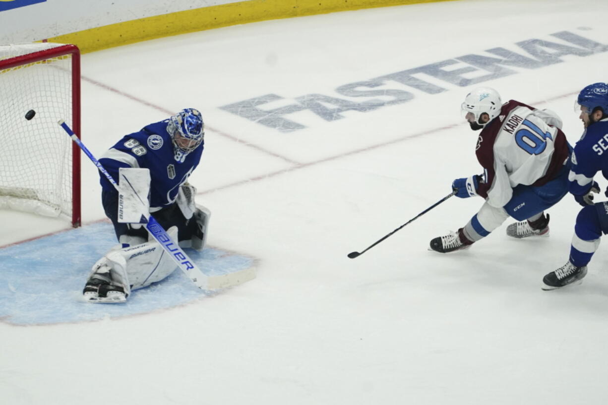 Colorado Avalanche center Nazem Kadri (91) shoots the puck past Tampa Bay Lightning goaltender Andrei Vasilevskiy (88) for a goal during overtime of Game 4 of the NHL hockey Stanley Cup Finals on Wednesday, June 22, 2022, in Tampa, Fla.