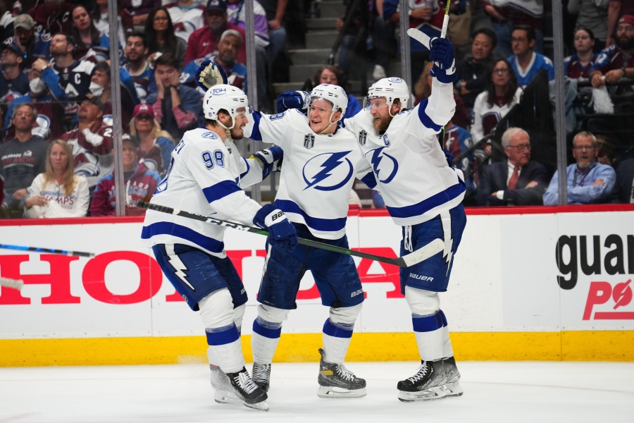 Tampa Bay Lightning left wing Ondrej Palat (18) celebrates a goal against the Colorado Avalanche with Mikhail Sergachev (98) and Steven Stamkos (91) during the third period in Game 5 of the NHL hockey Stanley Cup Final, Friday, June 24, 2022, in Denver.