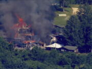 This image taken from video provided by WJLA shows crews battling a fire at Camp Airy for Boys in Thurmont, Md., on Wednesday, June 29, 2022. The building was empty when the fire broke out and no injuries have been reported, Frederick County Division of Fire & Rescue Services spokesperson Sarah Campbell said.  Residents and campers were not in the area of the fire, she said.