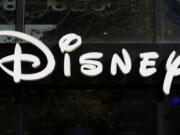 FILE - This Sept. 20, 2017, file photo shows a sign at the Disney store on the Champs Elysees Avenue in Paris, France.  The Supreme Court's decision to end the nation's constitutional protections for abortion has catapulted businesses of all types into the most divisive corner of politics. A rash of iconic names including The Walt Disney Company, Facebook parent Meta, and Goldman Sachs announced they would pay for travel expenses for those who want the procedure but can't get it in the states they live in.