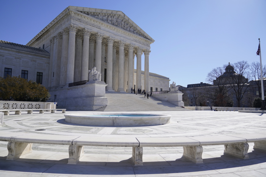 FILE - People stand on the steps of the U.S. Supreme Court, Feb.11, 2022, in Washington.