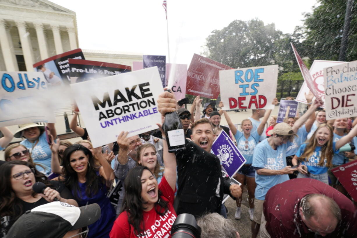 A celebration outside the Supreme Court, Friday, June 24, 2022, in Washington. The Supreme Court has ended constitutional protections for abortion that had been in place nearly 50 years -- a decision by its conservative majority to overturn the court's landmark abortion cases.