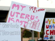 Abortion-rights activists march with signs carrying various messages during a demonstration from Heritage Library to Yuma City Hall, Wednesday, June 29, 2022, in Yuma, Ariz.
