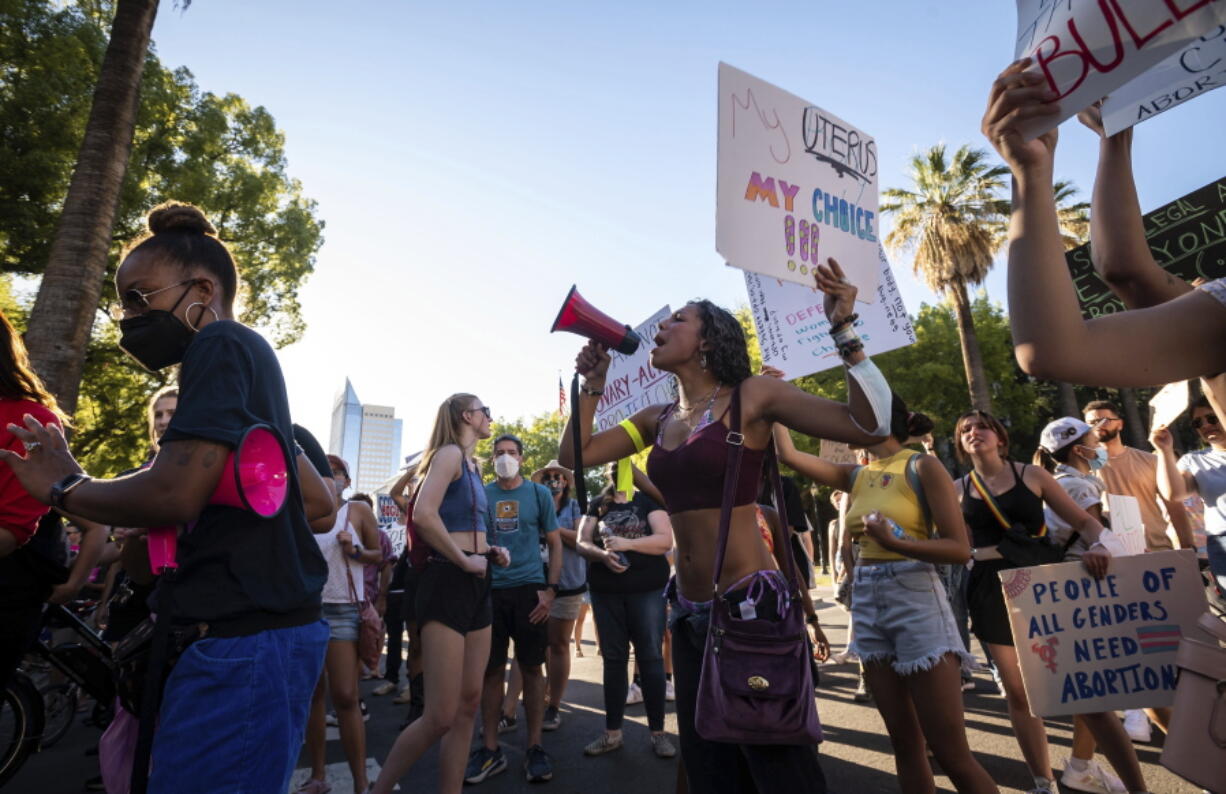 A woman who identified herself as Jada chants into a bullhorn outside the California Capitol during a protest of the U.S. Supreme Court's decision to effectively end Roe v. Wade on Friday, June 24, 2022, in Sacramento, Calif.