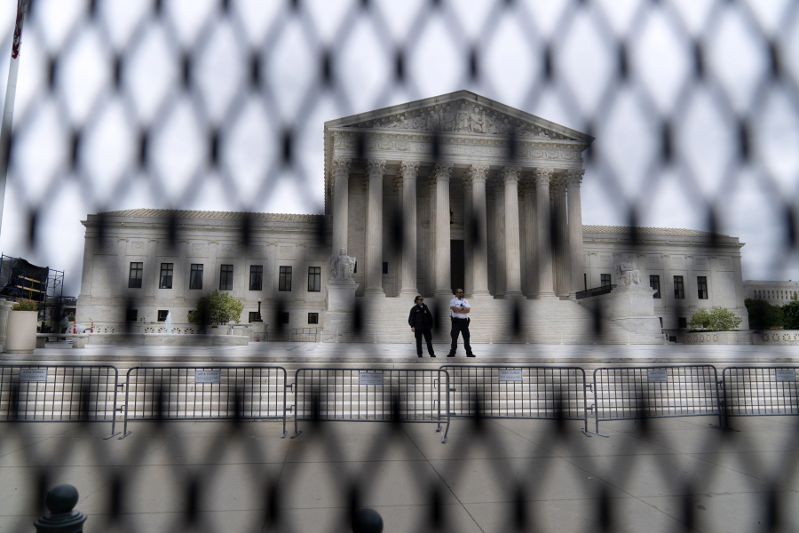 FILE - The U.S. Supreme Court is seen behind a fence who stands around the building on Thursday, May 5, 2022 in Washington. One proposal pending in Congress would provide additional security measures for the justices and another would offer more privacy and protection for all federal judges.