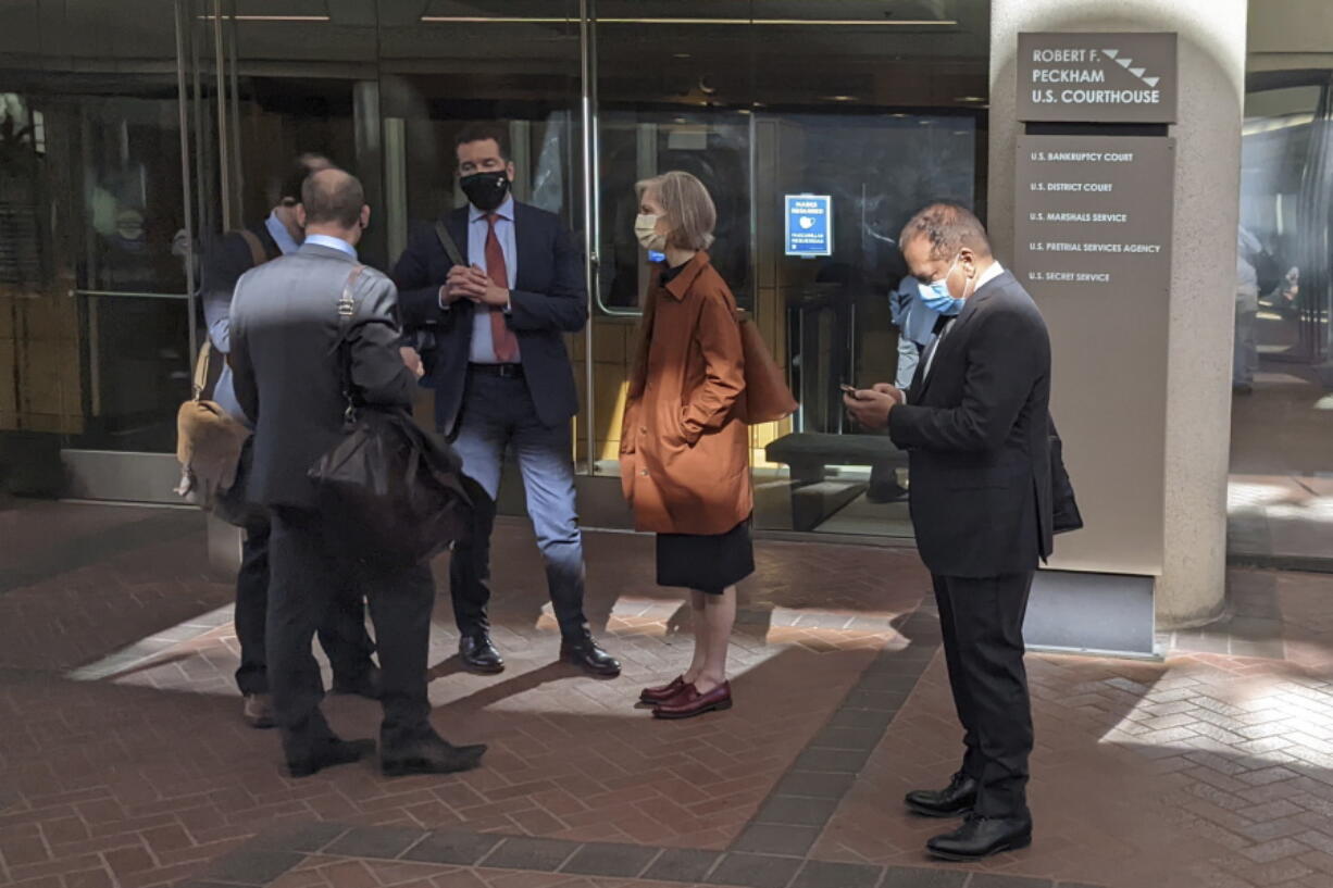FILE - Former Theranos executive Ramesh "Sunny" Balwani, right, stands near his legal team outside Robert F. Peckham U.S. Courthouse in San Jose, Calif., on March 1, 2022. A jury on Tuesday, June 21 is scheduled to hear closing arguments in the trial of Balwani, the former Theranos officer charged with teaming up with his secret lover, CEO Elizabeth Holmes, to carry out a massive fraud.