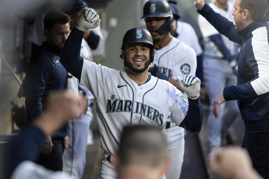 Seattle Mariners' Eugenio Suarez celebrates after hitting a two-run home run off Minnesota Twins starting pitcher Joe Ryan during the fourth inning of a baseball game Tuesday, June 14, 2022, in Seattle.