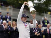 Matthew Fitzpatrick, of England, celebrates with the trophy after winning the U.S. Open golf tournament at The Country Club, Sunday, June 19, 2022, in Brookline, Mass.
