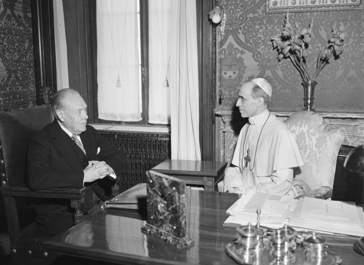 FILE - President Truman's envoy to the Vatican, Myron C. Taylor, left, has an audience with Pope Pius XII at Castelgandolfo near Rome, on Aug. 26, 1947. The Vatican has long defended its World War II-era pope, Pius XII, against criticism that he remained silent as the Holocaust unfolded, insisting that he worked quietly behind the scenes to save lives.