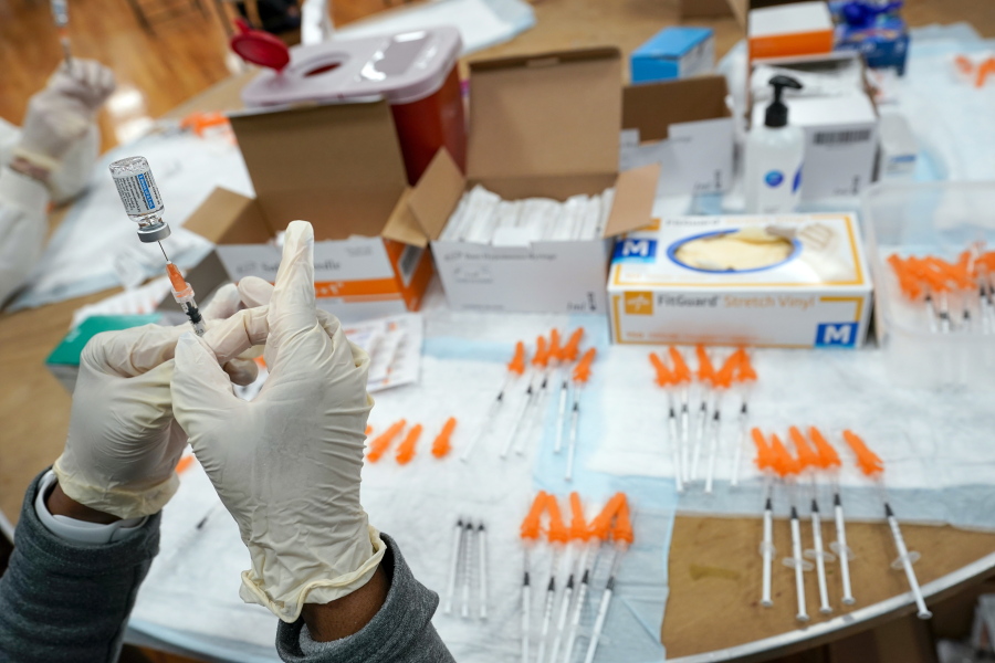 FILE - A Northwell Health registered nurse fills a syringe with a COVID-19 vaccine at a pop up vaccination site the Albanian Islamic Cultural Center, April 8, 2021, in the Staten Island borough of New York. The Food and Drug Administration on Thursday, June 30, 2022 recommended that COVID-19 booster shots be modified to better match more recent variants of the coronavirus.