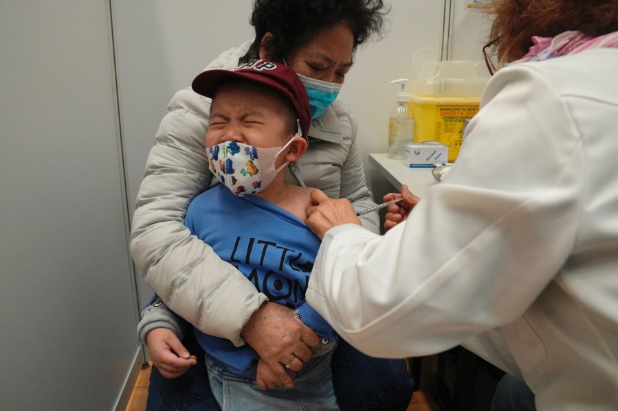 FILE - A boy receives a dose of China's Sinovac COVID-19 coronavirus vaccine at a community vaccination center in Hong Kong on Feb. 25, 2022. U.S. government advisers met Wednesday, June 15, 2022 to decide whether to endorse COVID-19 shots for babies, toddlers and preschoolers, moving the nation closer to vaccinations for all ages. According to the World Health Organization, 12 countries are vaccinating kids under 5.