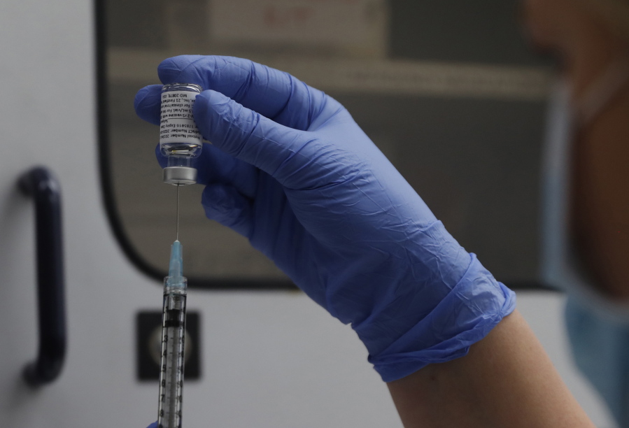 FILE - A vial of the Phase 3 Novavax coronavirus vaccine is seen ready for use in the trial at St. George's University hospital in London, Oct. 7, 2020. The Novavax COVID-19 vaccine that could soon win federal approval may offer a boost for the U.S. military: an opportunity to get shots into some of the thousands of service members who have refused the vaccine for religious reasons.
