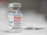 FILE - A vial of the Moderna COVID-19 vaccine is displayed on a counter at a pharmacy in Portland, Ore. on Dec. 27, 2021. U.S. health authorities are facing a critical decision: whether to offer COVID-19 booster shots this fall that better match the omicron variant even though the coronavirus already has spawned still more mutants. Moderna and Pfizer are testing updated booster candidates, and advisers to the U.S. Food and Drug Administration will debate Tuesday, June 28, 2022, if it's time for a switch, setting the stage for similar moves by other countries.