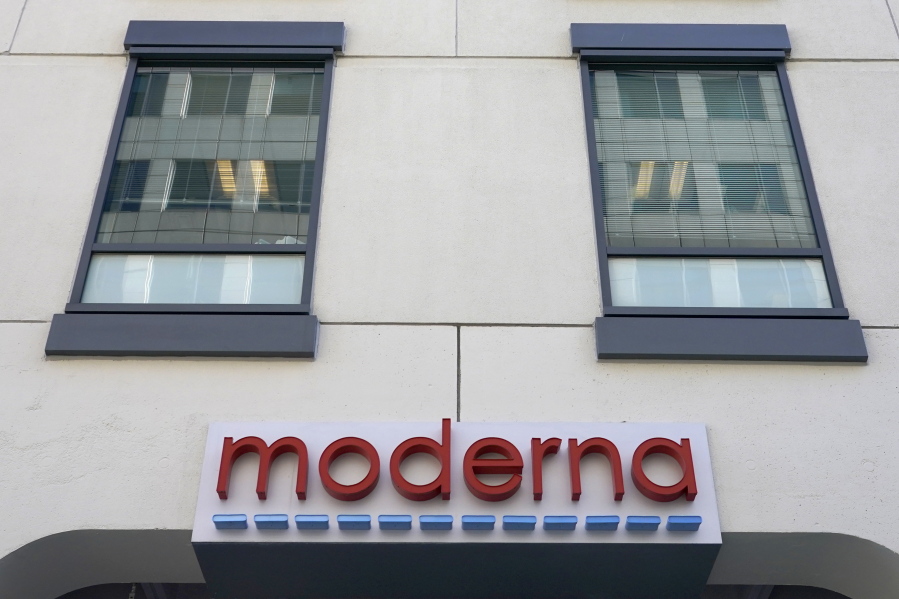 FILE - In this Dec. 15, 2020, file photo, a sign for Moderna, Inc. hangs on its headquarters in Cambridge, Mass.  Moderna's experimental COVID-19 vaccine that combines its original shot with protection against the omicron variant appears to work, the company announced Wednesday, June 8, 2022.