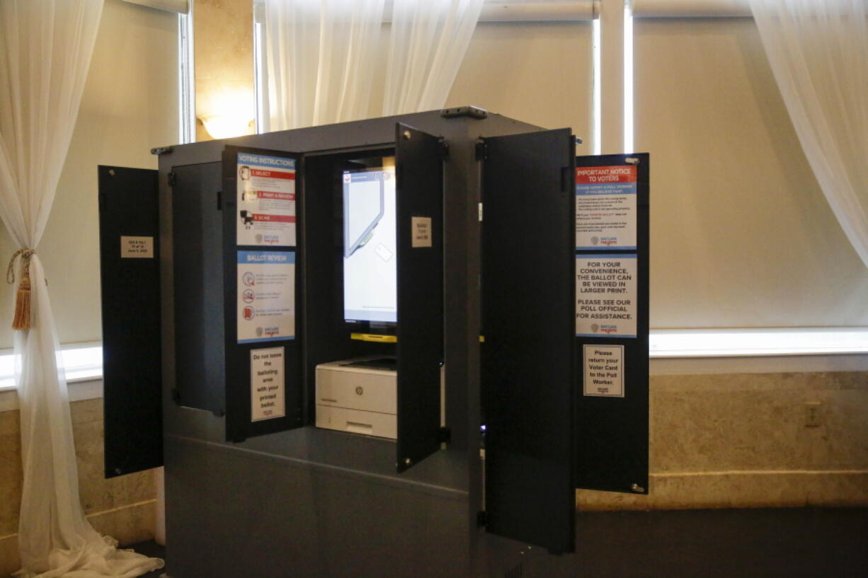 FILE - New state-issued voting machines used for the Georgia primary election on June 9, 2020, are seen at Park Tavern in Atlanta. The U.S. Cybersecurity and Infrastructure Security Agency released a final version Friday, June 3, 2022, of an advisory it previously sent state officials on voting machine vulnerabilities in Georgia and other states that voting integrity activists say weakens a security recommendation on using barcodes to tally votes.