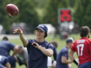 Amanda Ruller, who is currently working as an assistant running backs coach for the NFL football Seattle Seahawks through the league's Bill Walsh Diversity Fellowship program, passes a football during NFL football practice on June 8, 2022, in Renton, Wash. Ruller's job is scheduled to run through the Seahawks' second preseason game in August. (AP Photo/Ted S.