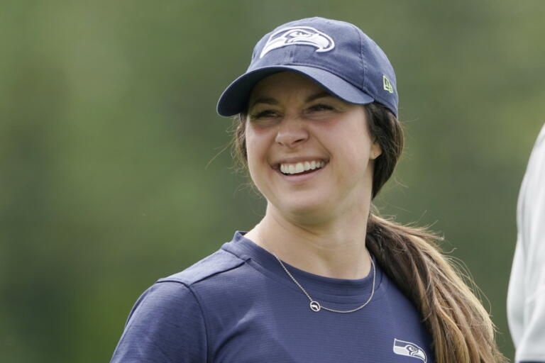 Amanda Ruller, who is currently working as an assistant running backs coach for the NFL football Seattle Seahawks through the league's Bill Walsh Diversity Fellowship program, stands on the field during NFL football practice on June 8, 2022, in Renton, Wash. Ruller's job is scheduled to run through the Seahawks' second preseason game in August. (AP Photo/Ted S.