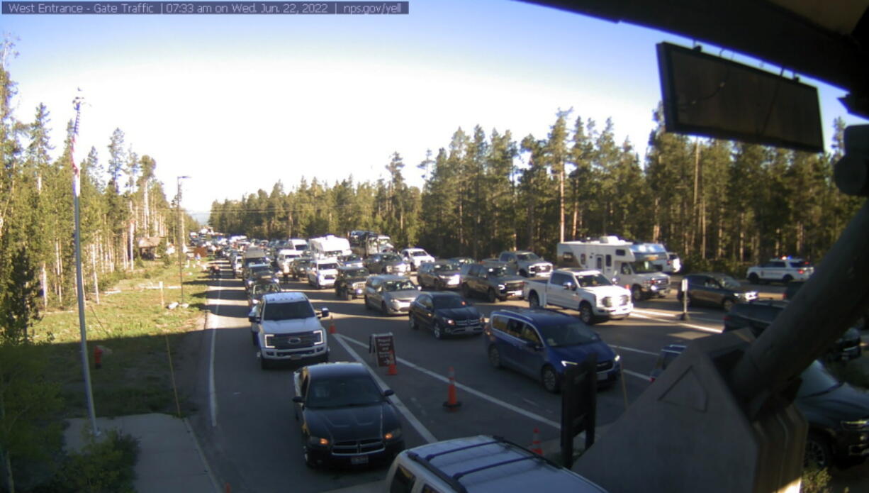 This photo provided by National Park Service shows West Entrance gate traffic on Wednesday, June 22, 2022 at Yellowstone National Park in Montana. Visitors will return to a changed landscape in Yellowstone National Park on Wednesday as it partially reopens following record floods that reshaped the park's rivers and canyons, wiped out numerous roads and left some areas famous for their wildlife viewing inaccessible, possibly for months to come.