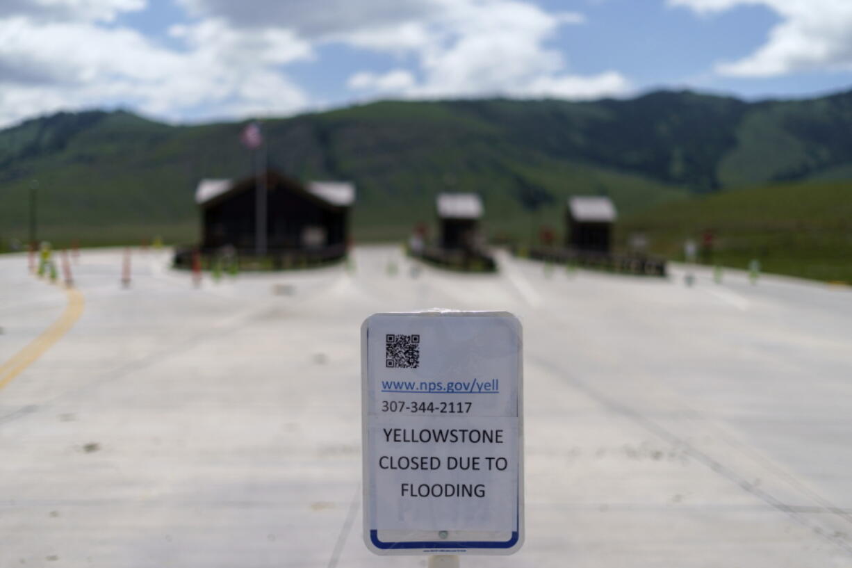 FILE - The entrance to Yellowstone National Park, a major tourist attraction, sits closed due to the historic floodwaters on June 15, 2022, in Gardiner, Mont. Created in 1872 as the United States was recovering from the Civil War, Yellowstone was the first of the national parks that have been referred to as America's best idea. Now, the home to soaring geysers and some of the country's most plentiful and diverse wildlife is facing its biggest challenge in decades.