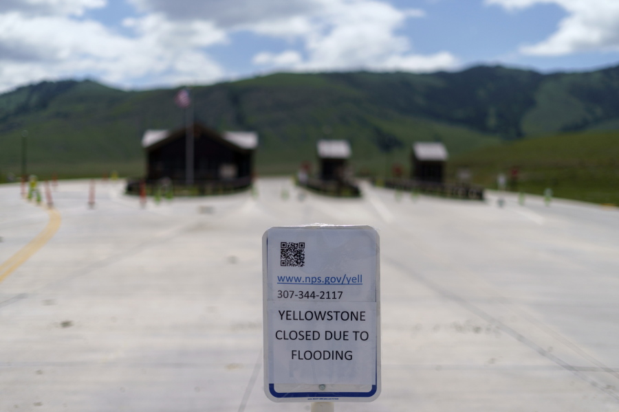 FILE - The entrance to Yellowstone National Park, a major tourist attraction, sits closed due to the historic floodwaters on June 15, 2022, in Gardiner, Mont. Created in 1872 as the United States was recovering from the Civil War, Yellowstone was the first of the national parks that have been referred to as America's best idea. Now, the home to soaring geysers and some of the country's most plentiful and diverse wildlife is facing its biggest challenge in decades.
