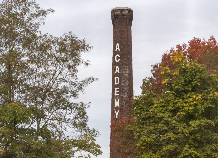 Fall colors frame the Providence Academy smokestack last October. It is set to be demolished in August.