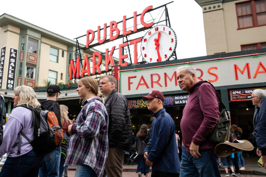 Visitors walk around Pike Place Market on Friday, June 17, 2022. On Friday, three cruise ships docked in Elliot Bay, sending a wave of tourists to the market.