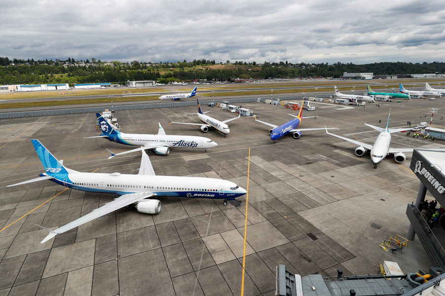 An Icelandair 737 taxis past the 737 MAX family of airplanes outside Boeing's Seattle Delivery Center at Boeing Field in July.