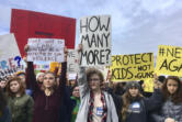 FILE- This March 14, 2018 file photos shows students at Roosevelt High School taking part in a protest against gun violence in Seattle. In the wake of a Valentine's Day shooting that killed 17, a handful of Parkland, Fla., teenagers are on the cusp of pulling off what could be one of the largest marches in history with nearly 1 million expected in DC and more than 800 sister marches planned across every continent.