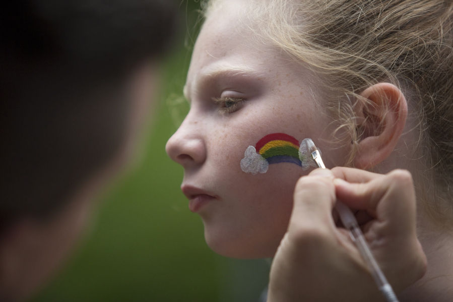 Ileah Sutton, 9, gets a rainbow painted on her face at the 2016 Saturday in the Park Pride in Esther Short Park in downtown Vancouver.