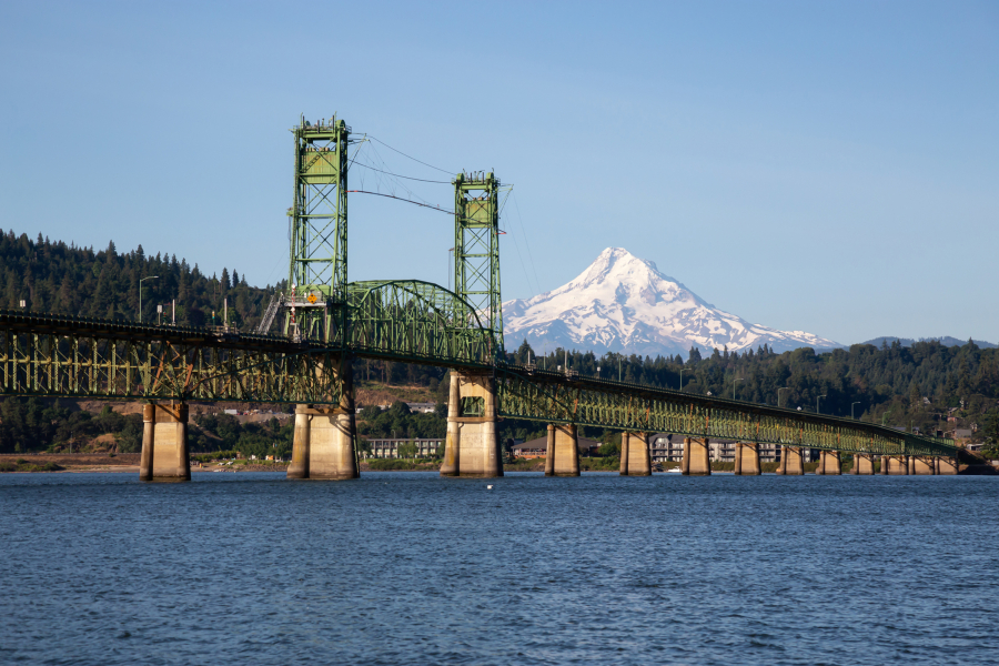 The Hood River Bridge over the Columbia River with Mount Hood in the background is seen from White Salmon.