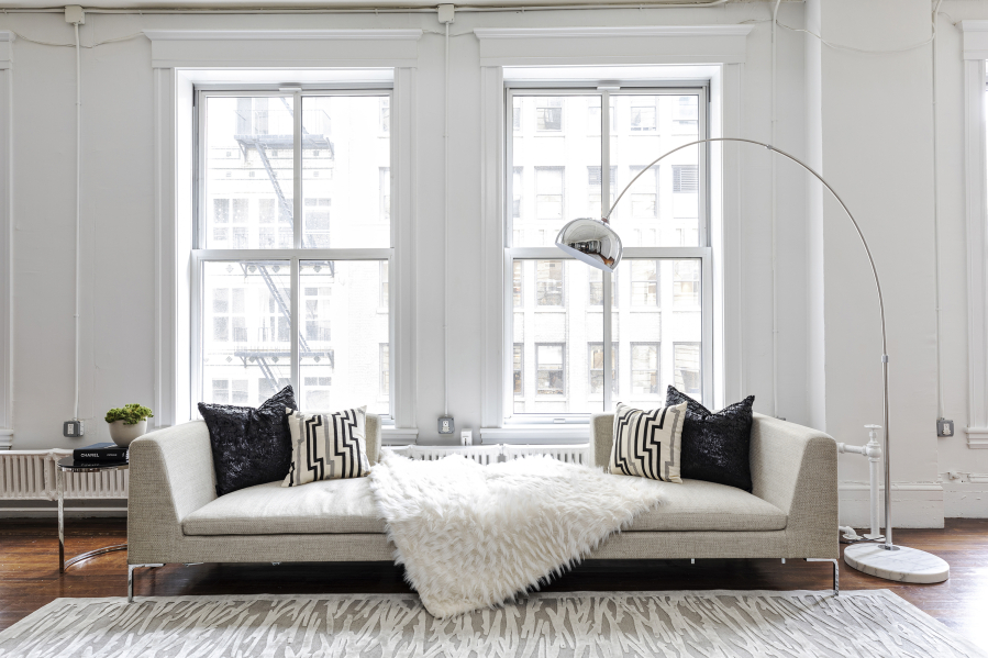 Accents such as an area rug and toss pillows help to create a modern setting.