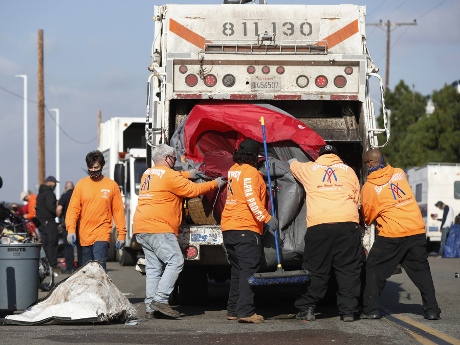 Workers for the Alpha Project and the city of San Diego remove homeless encampments on Sports Arena Boulevard on Tuesday, Feb. 1, 2022 in San Diego. (K.C.