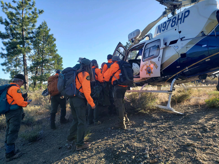 Search and rescue team members from the Nevada County Sheriff's Office help into a helicopter a man who fell 70 feet while hiking in the Tahoe National Forest. The man???s border collie, Saul, led rescuers to him.