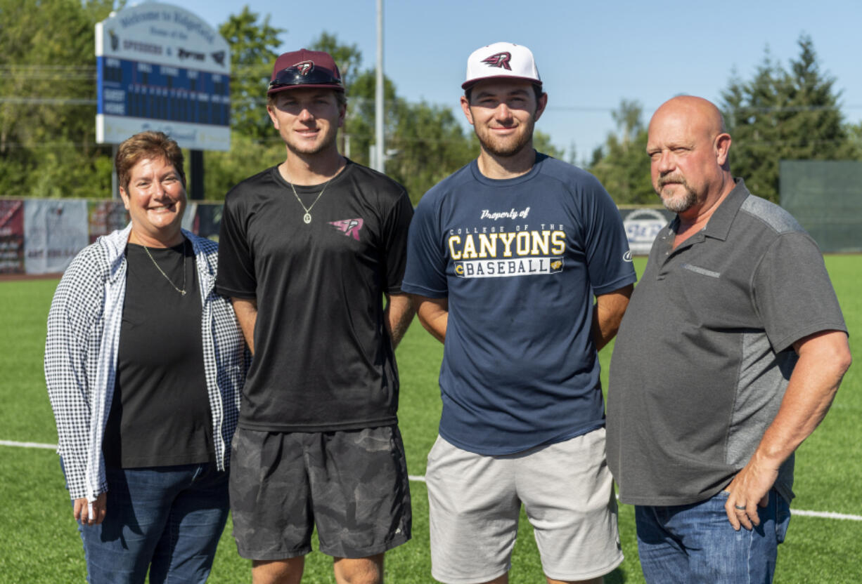 Jodi, left, and Tony Rayburn, right, stand with Raptors players Mikey, center left, and Doyle Kane at the Ridgefield Outdoor Recreation Complex. The Rayburns are the host family for the Kane brothers, who hail from Southern California, while they play for the Raptors this summer.