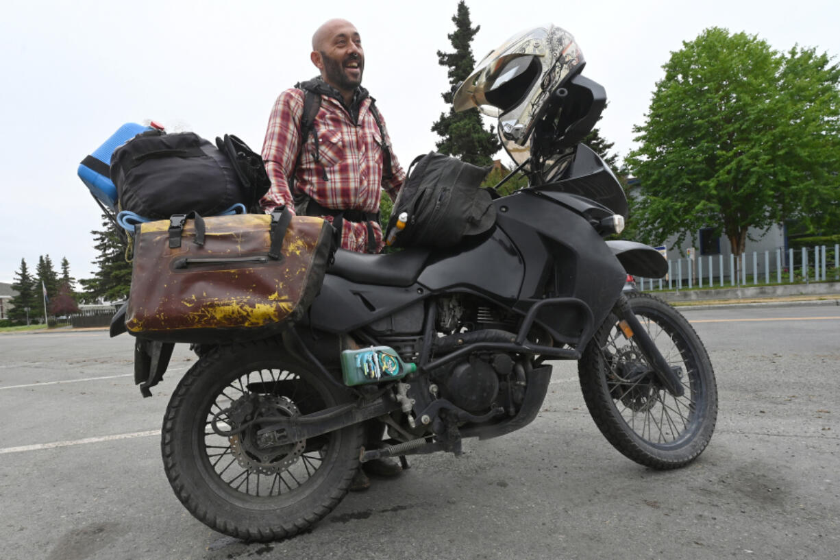 Diego Saad takes a break in Delaney Park Strip near downtown Anchorage on July 12. He rode his Kawasaki KLR 650 from Argentina to Alaska, a journey that began five years ago. He plans to travel north to the Arctic Circle.