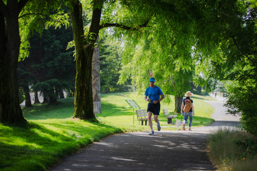 Joggers run through Centennial Park along Elliott Bay Trail in Seattle on July 5, 2022.