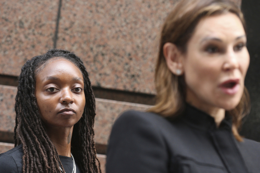 Attorney Tamara Holder, right, speaks as Amazon worker Tori Davis listens during a news conference outside an Amazon Go in Chicago on July 27, 2022. Twenty-six Amazon workers from the MDW2 warehouse in Joliet are filing complaints with the EEOC alleging Amazon is forcing them to work in a dangerous and racially hostile environment.