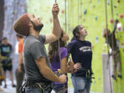 Bryan Caldwell, a climbing instructor at The Source Climbing Center, belays as a student climbs a wall during a class Oct. 17, 2012, in downtown Vancouver.