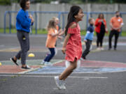 Hazel Dell Elementary School first-grader and Afghan refugee Murwarid Azizpour, 6, leaps into action while participating in field day with her classmates in the week before summer break.