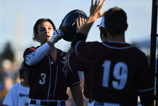 Raptors outfielder Jacob Sharp, left, celebrates with teammates Tuesday, June 28, 2022, during a game between the Ridgefield Raptors and the Portland Pickles at the Ridgefield Outdoor Recreation Complex.