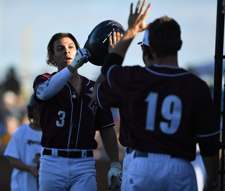 Raptors outfielder Jacob Sharp, left, celebrates with teammates Tuesday, June 28, 2022, during a game between the Ridgefield Raptors and the Portland Pickles at the Ridgefield Outdoor Recreation Complex.